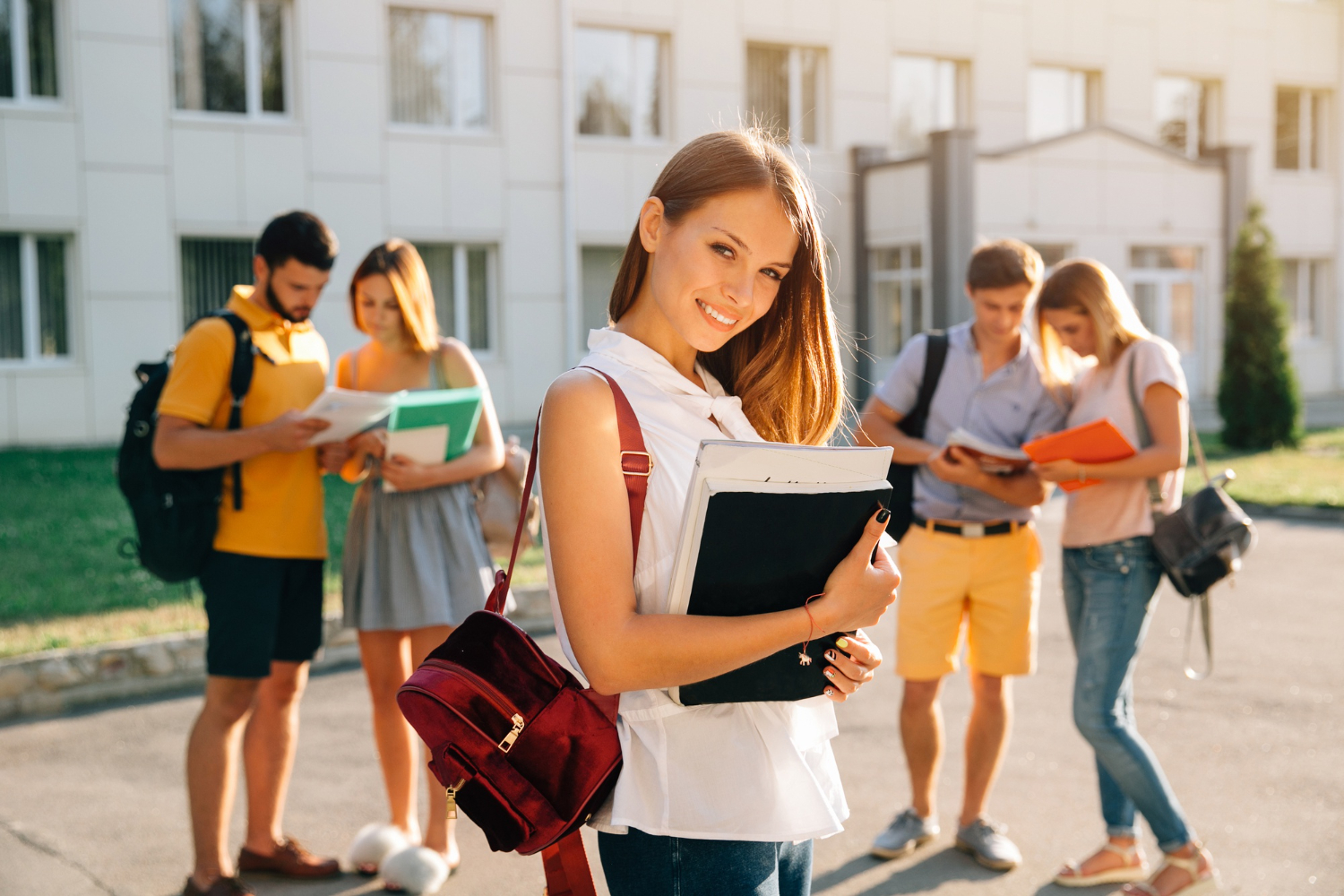 Handsome-young-girl-with-red-velvet-backpack-holding-books