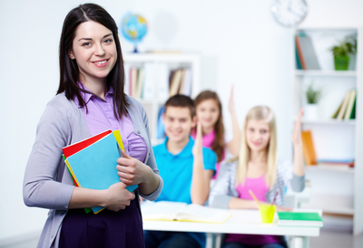 Happy-teacher-with-students-background